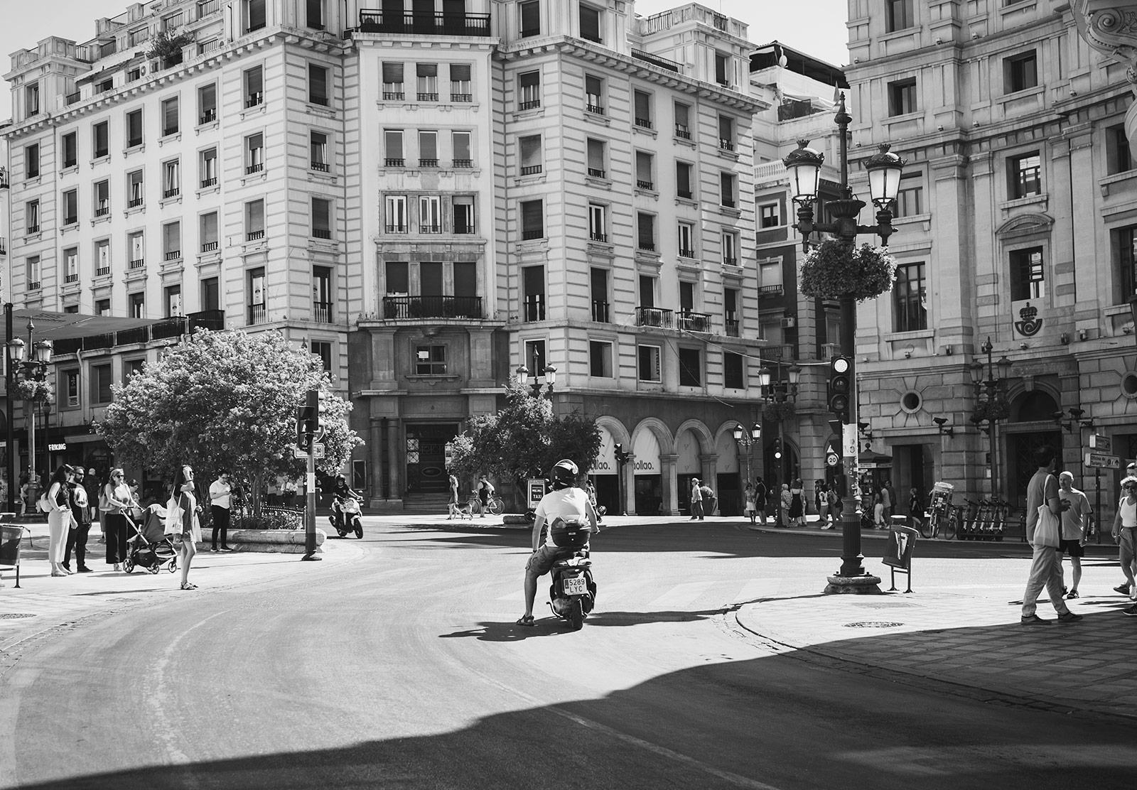 Man on moped at traffic lights
