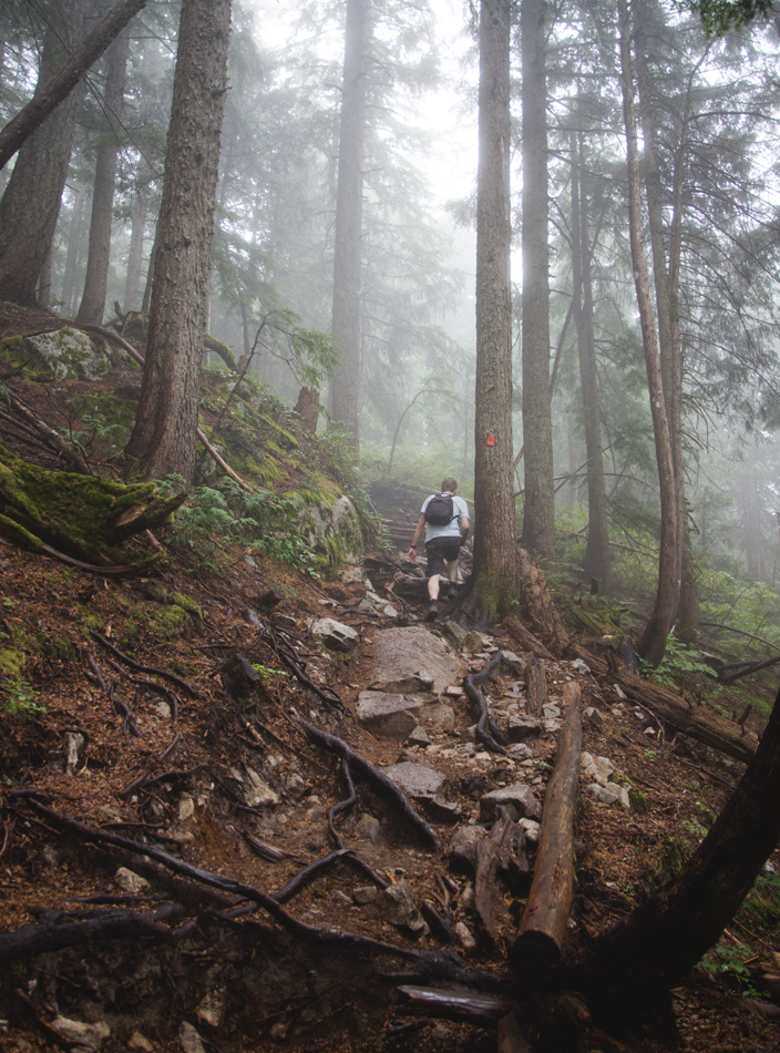 Man scrambling up rocks