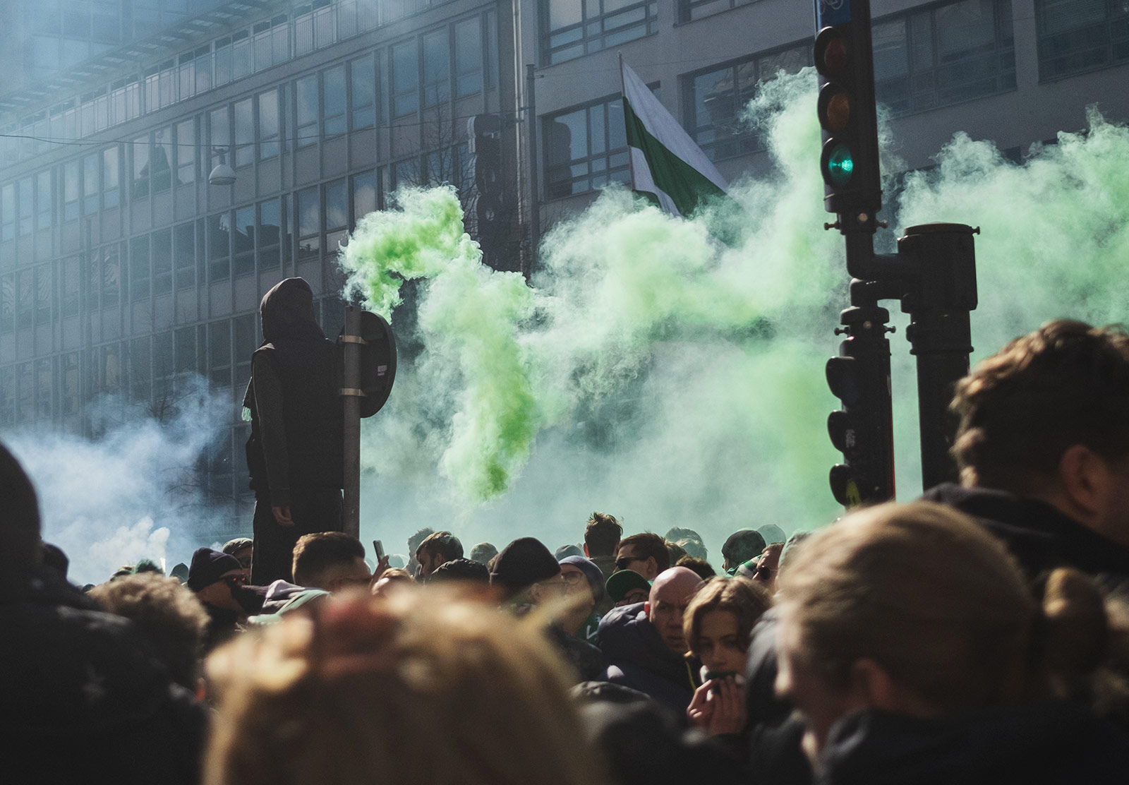Man with green gas canister in hand