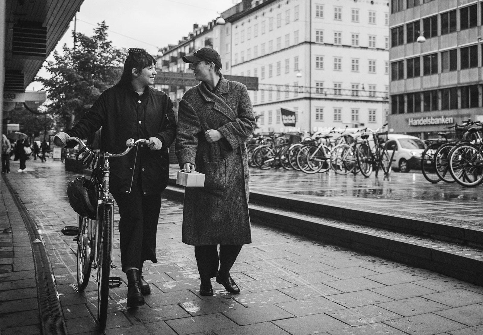 Two people walking with a bike