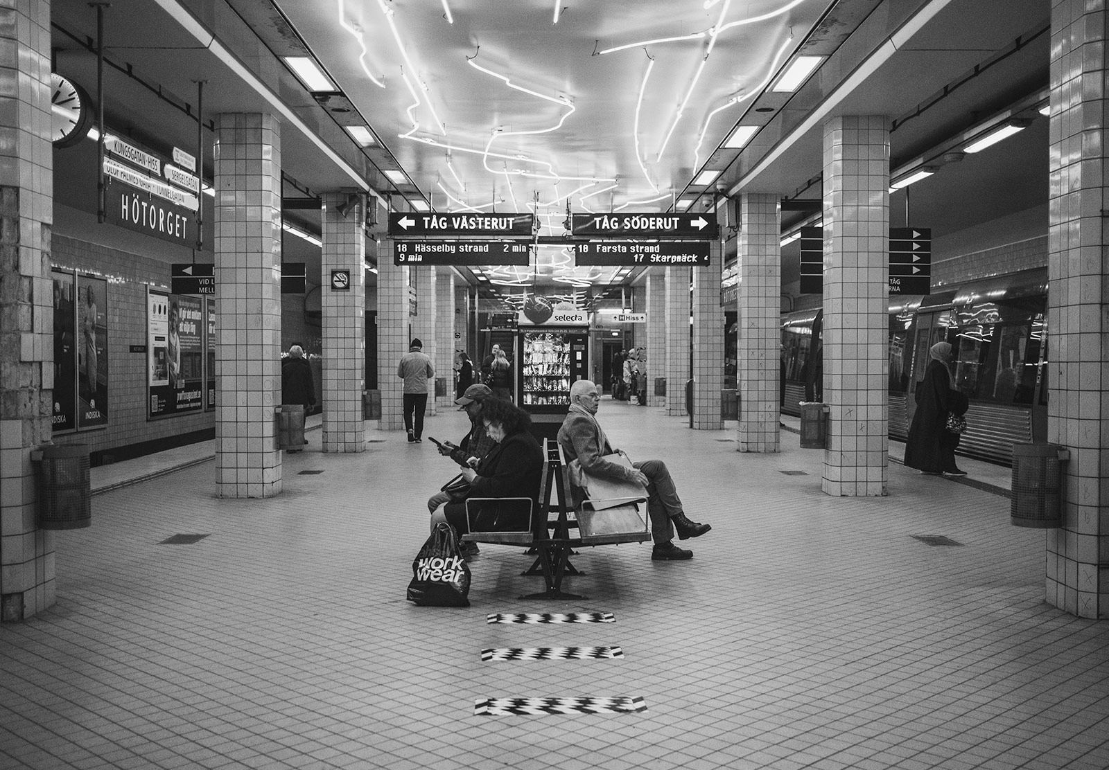 People sat on bench in train station