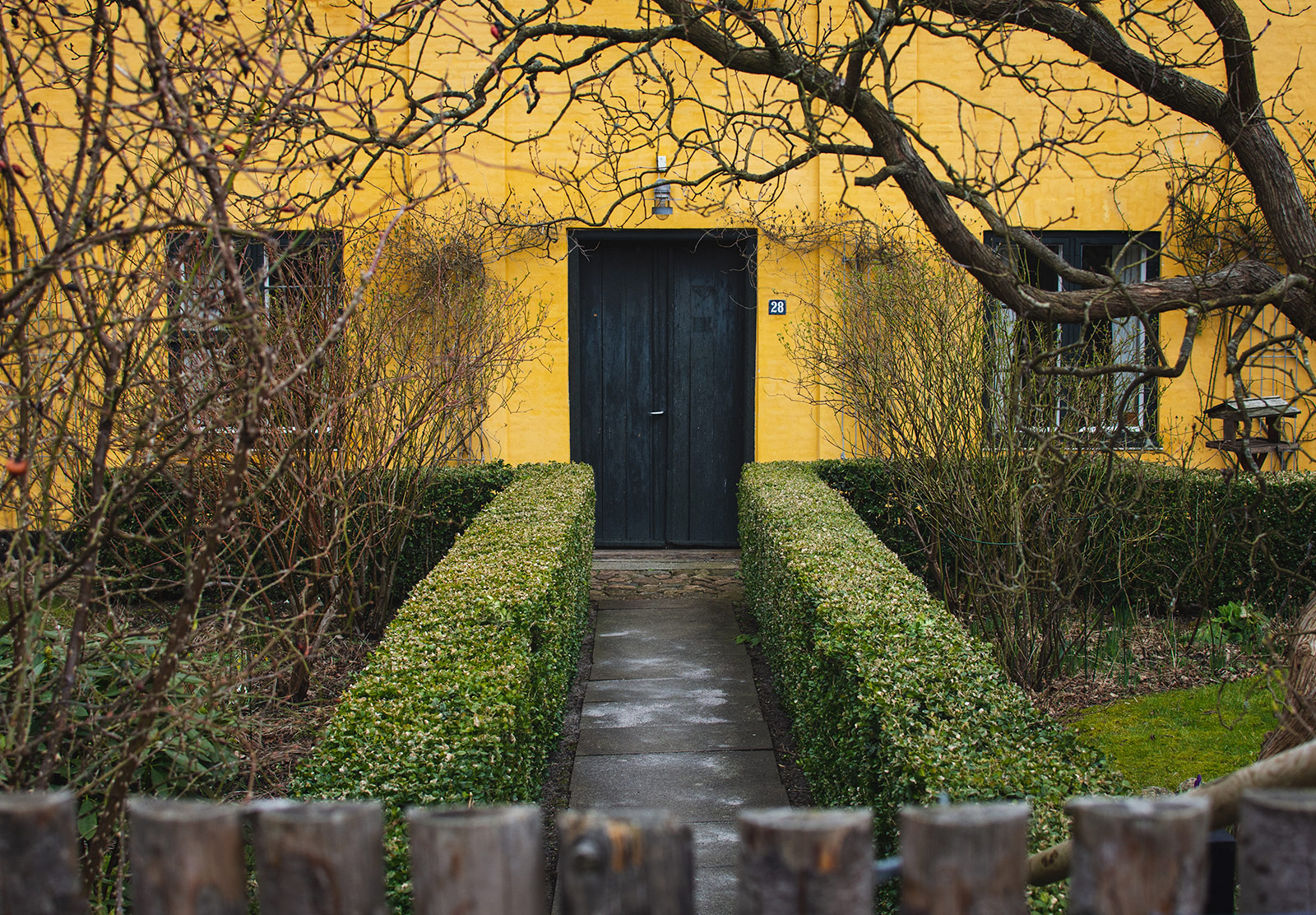 Black door on yellow building