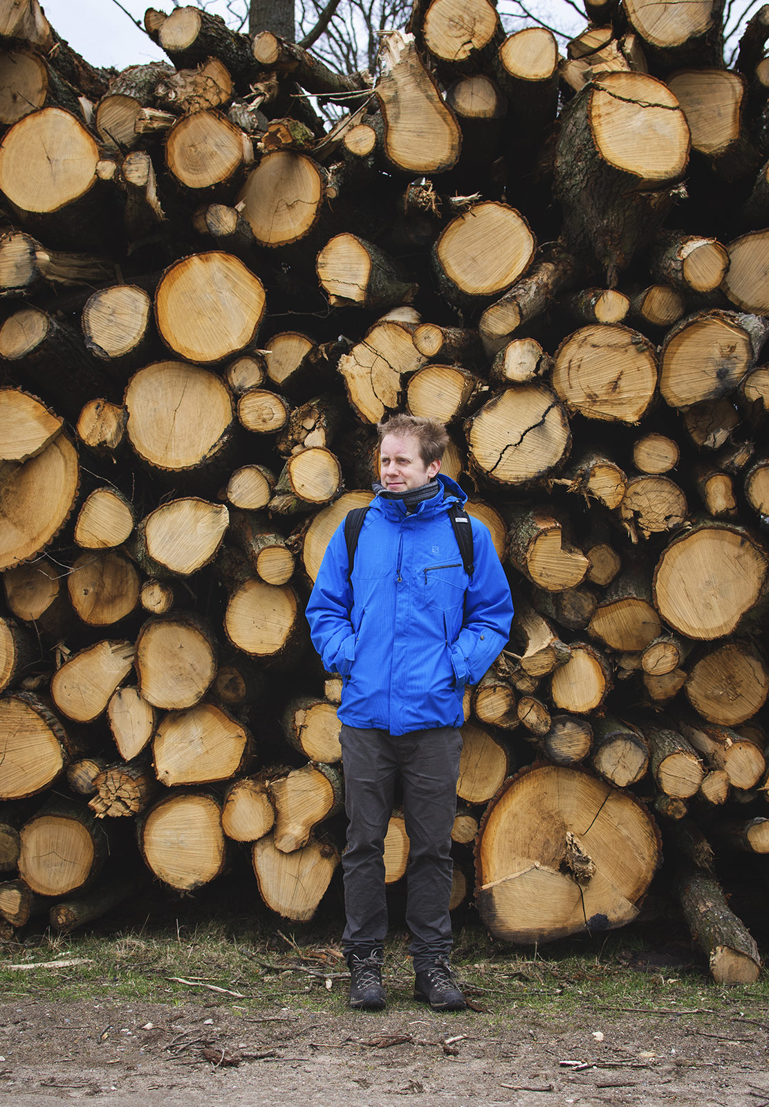 Man with pile of tree stumps