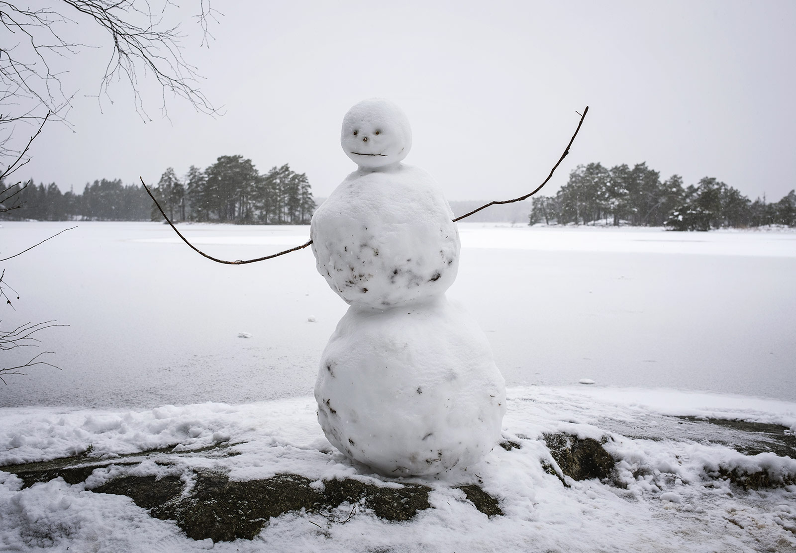 Snowman by lake