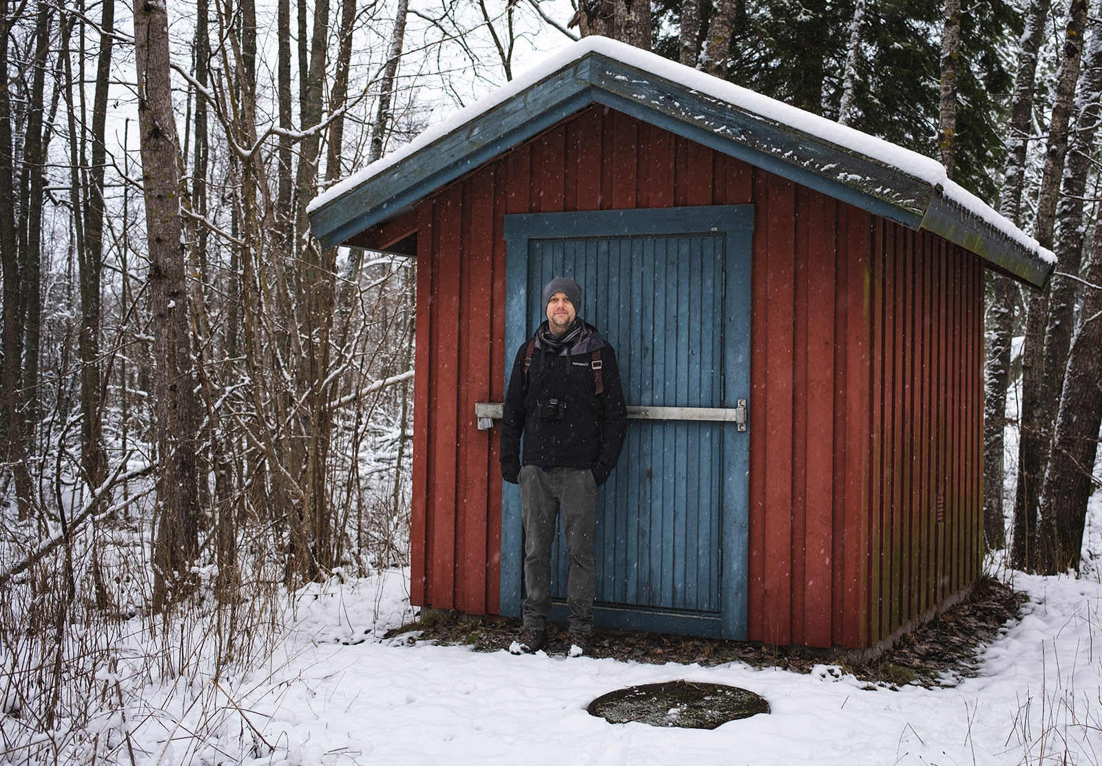 Man stood outside wooden building