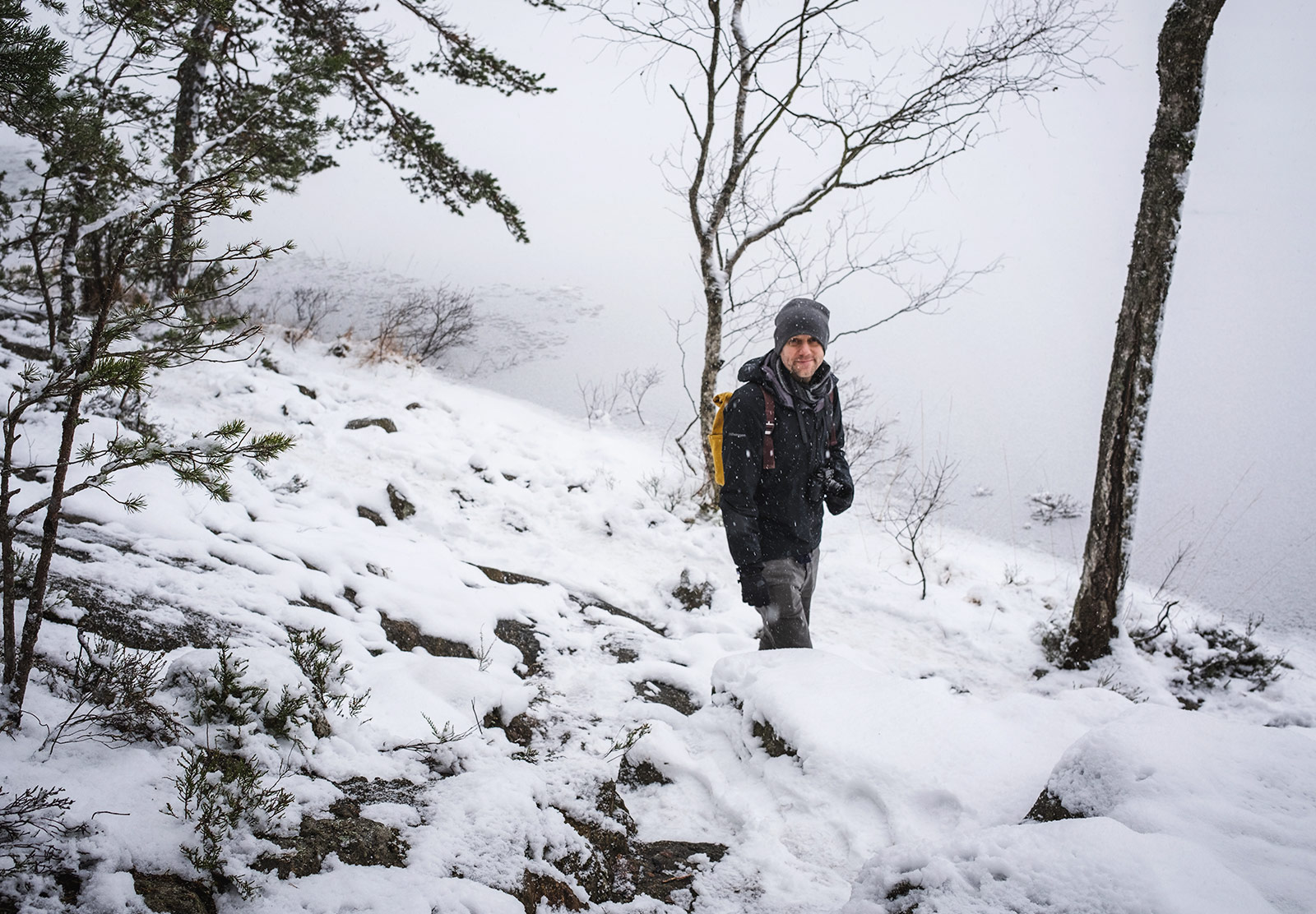 Man standing by frozen lake