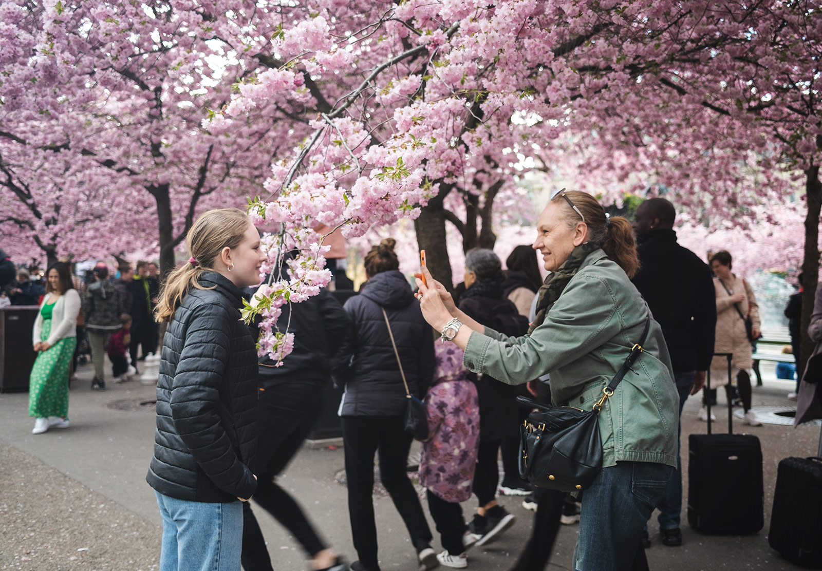 Woman photographing daughter