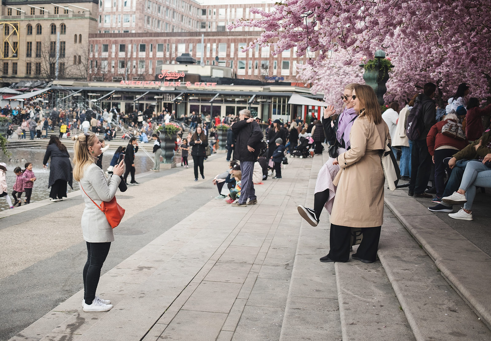 Women standing in front of cherry blossom