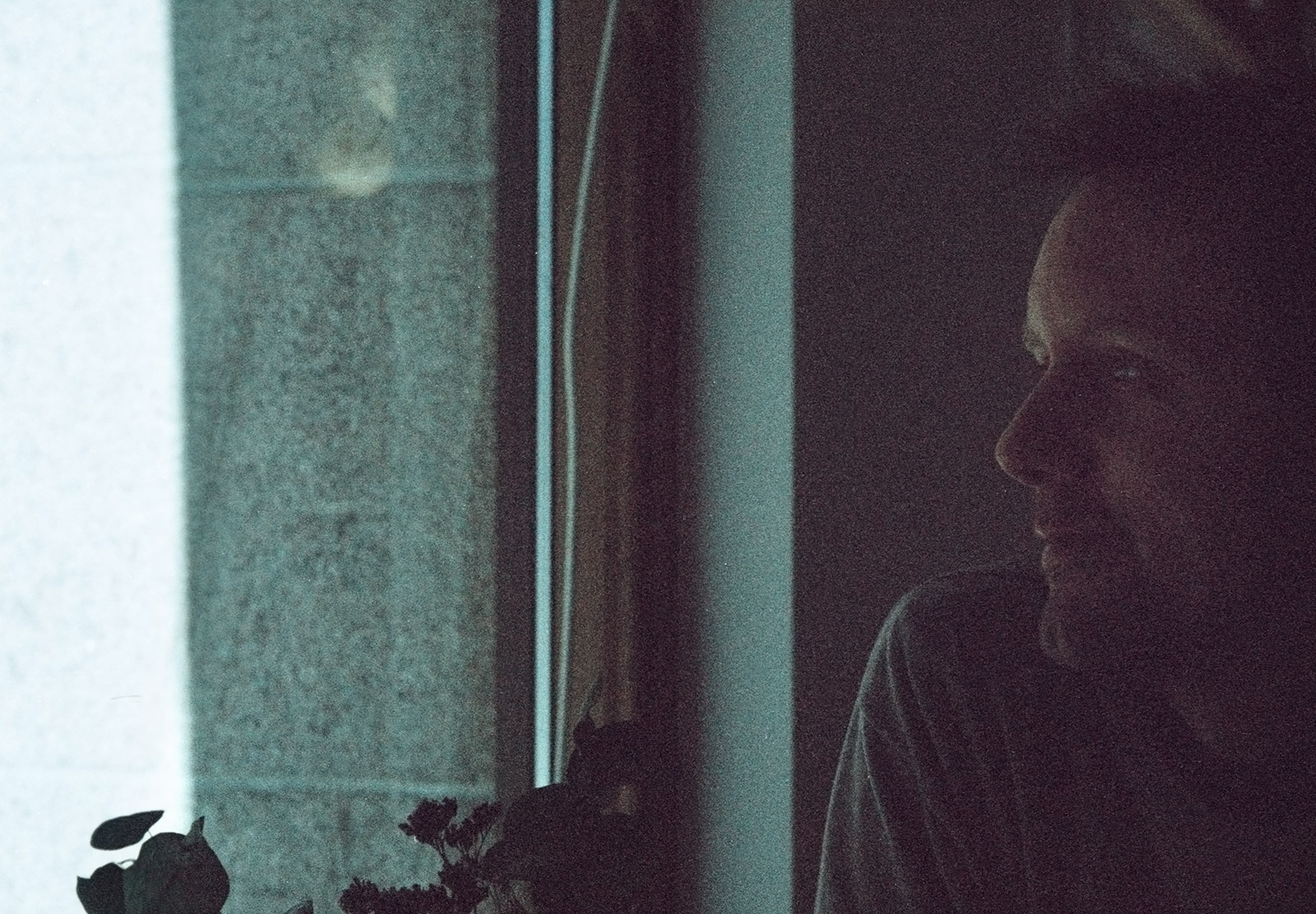 Man looking out window
