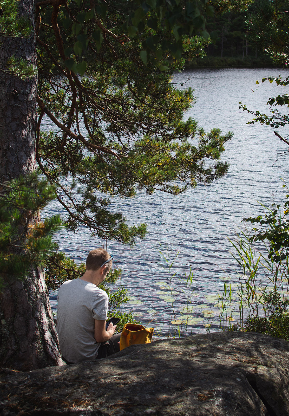 Man sat next to lake
