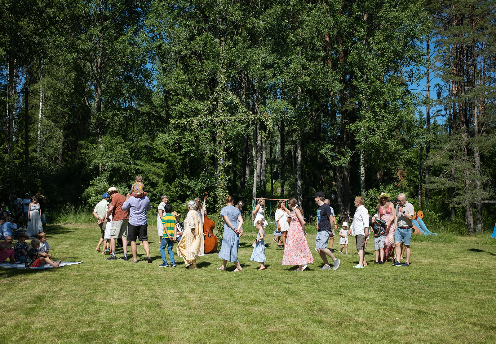 People dancing around pole