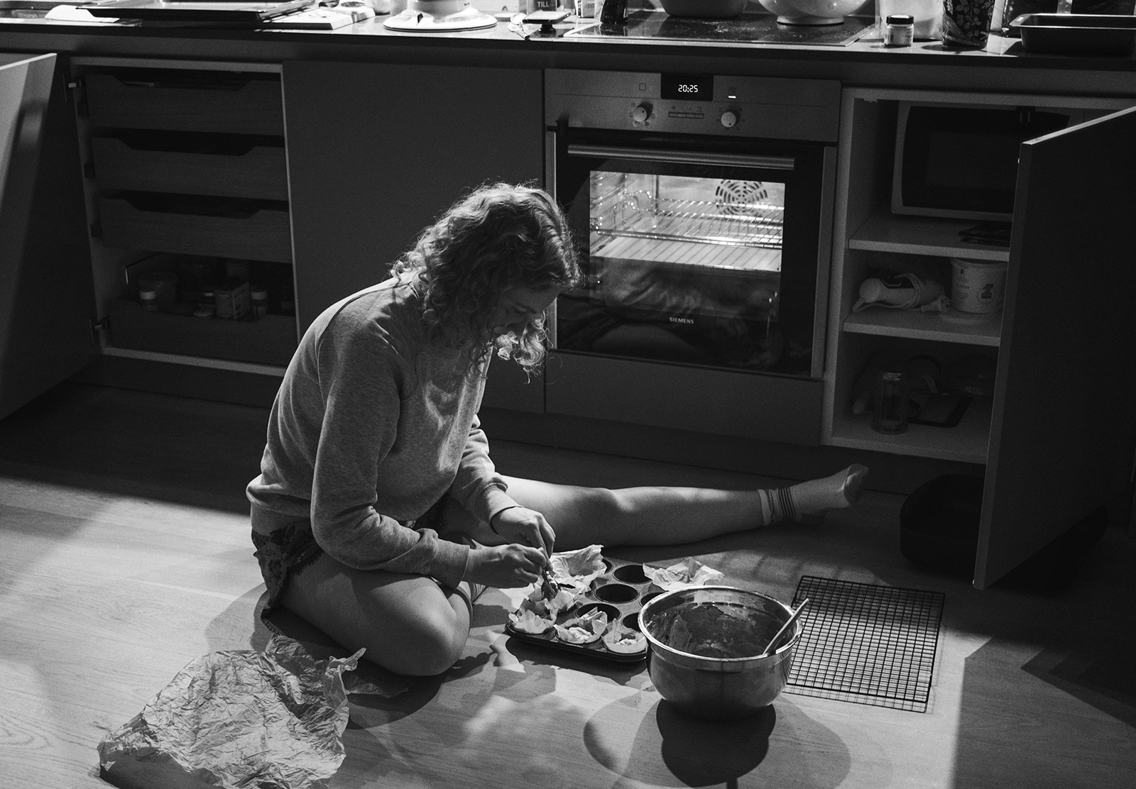 Woman sat on floor with baking tray