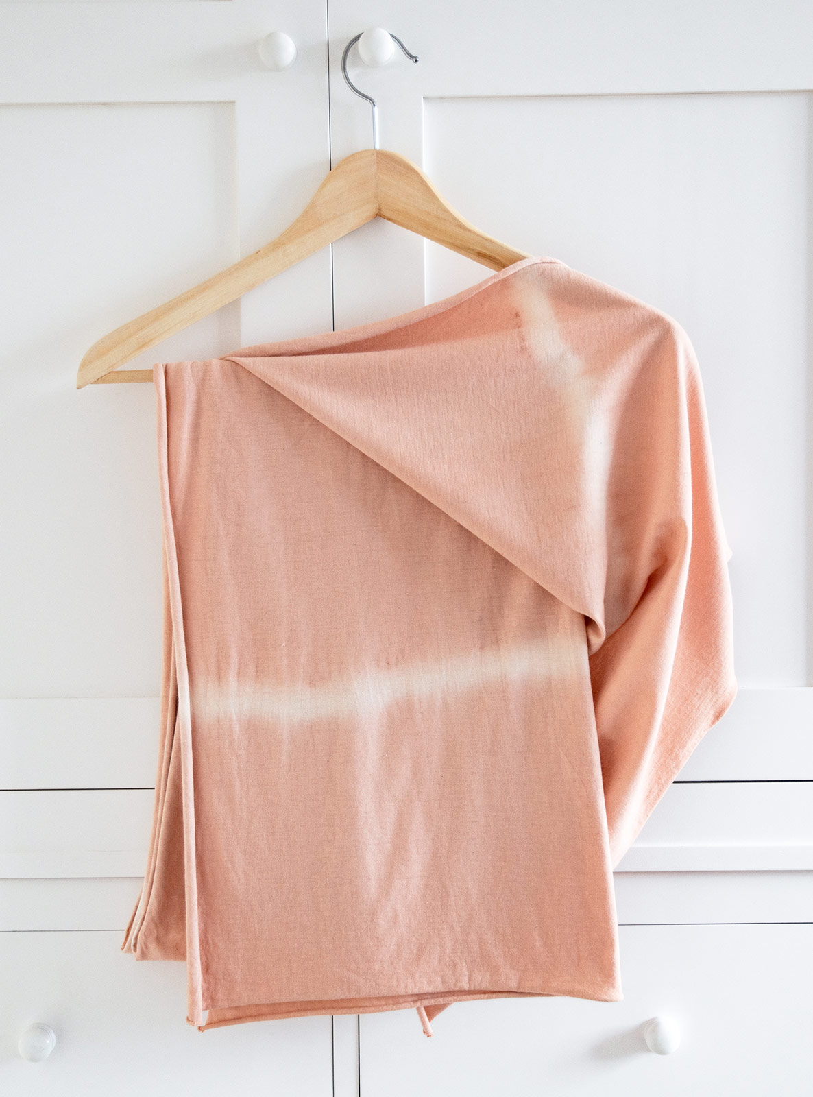 Pink scarf with stripes hanging