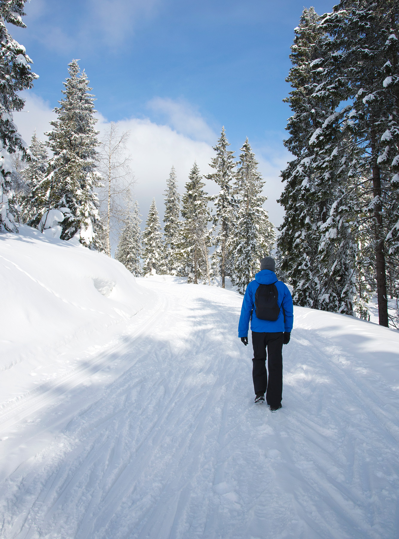 Man walking on snow trail