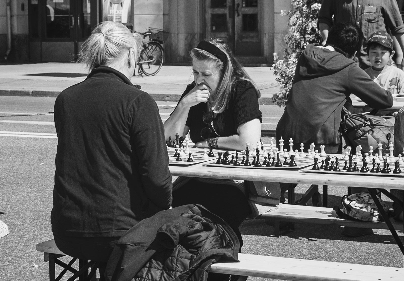 Two people playing chess outdoors