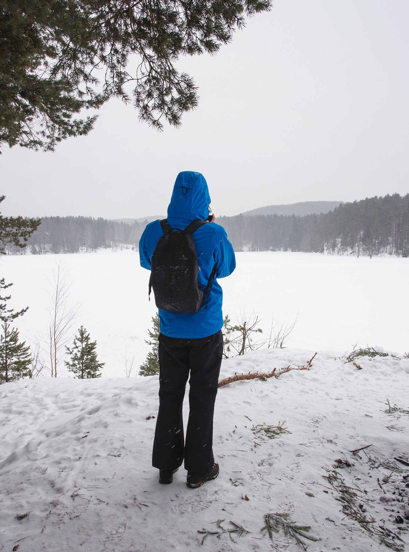 Man looking over frozen lake
