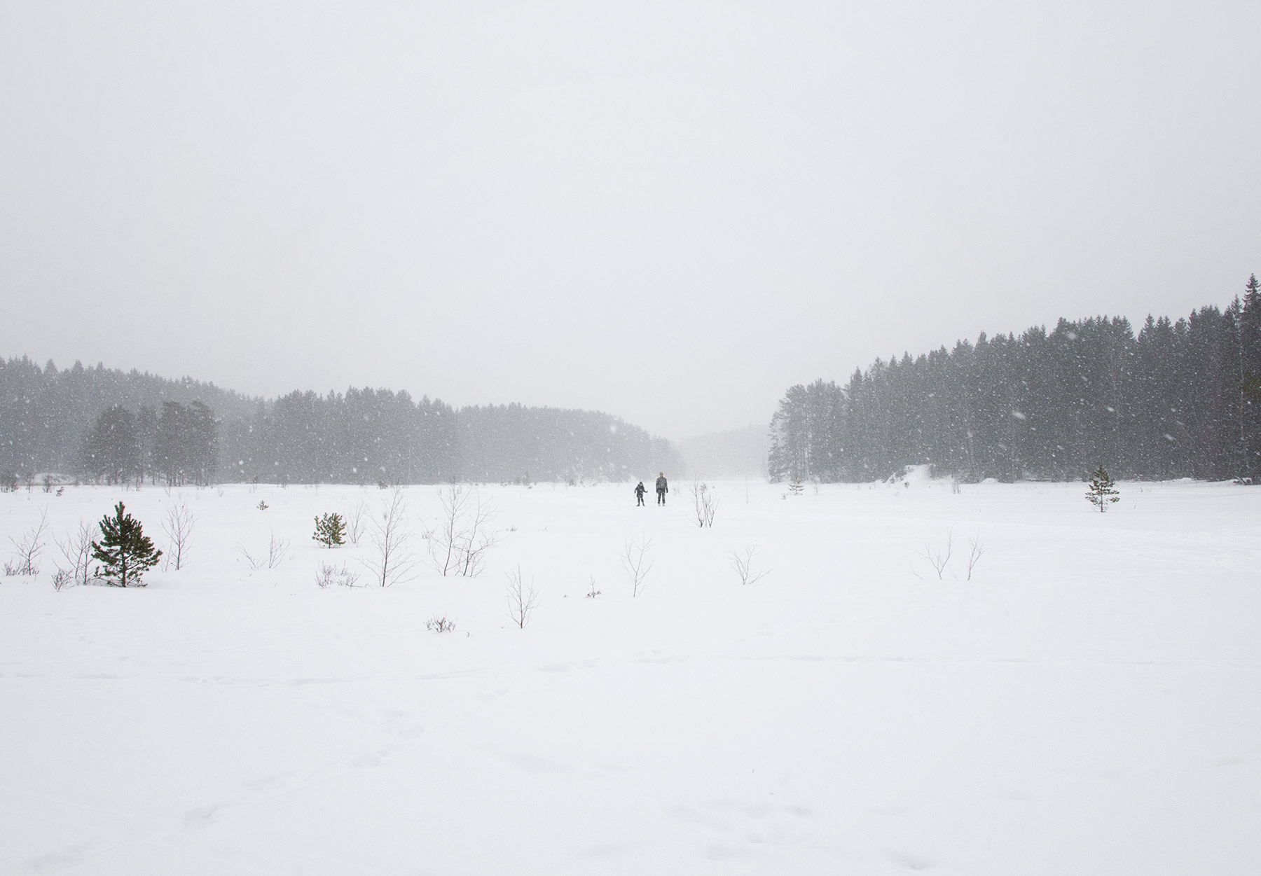 Tiny figures on frozen lake