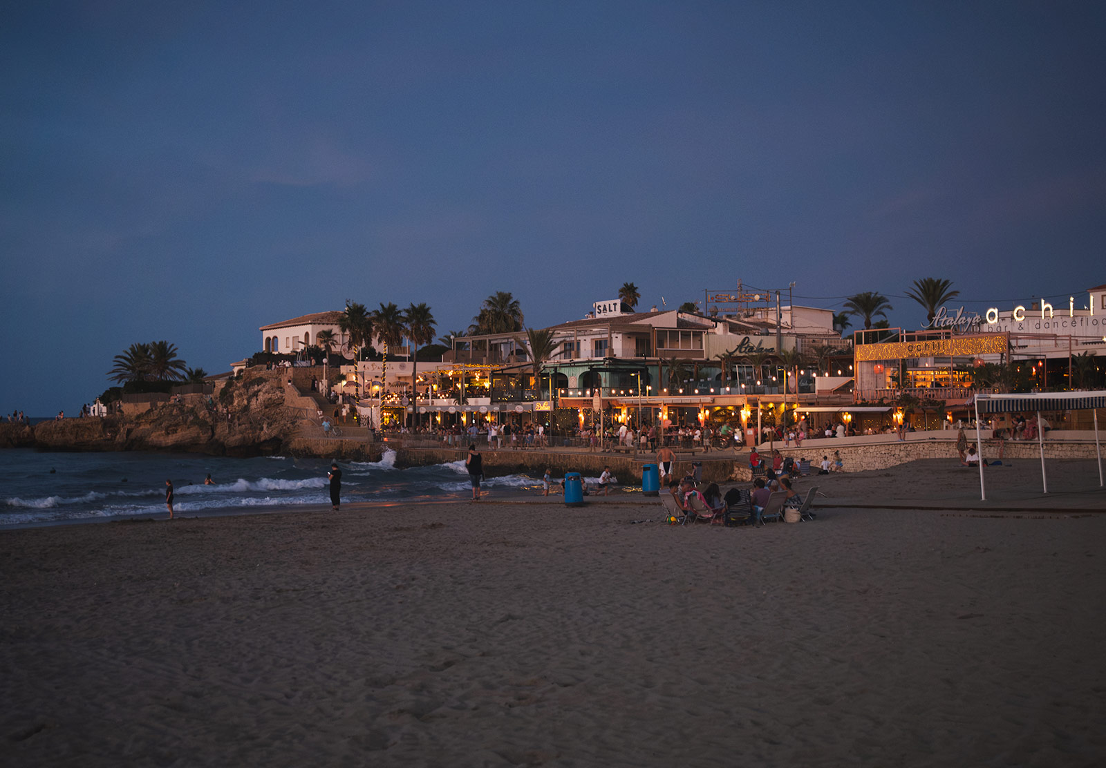 Glowing lights on the beach at night