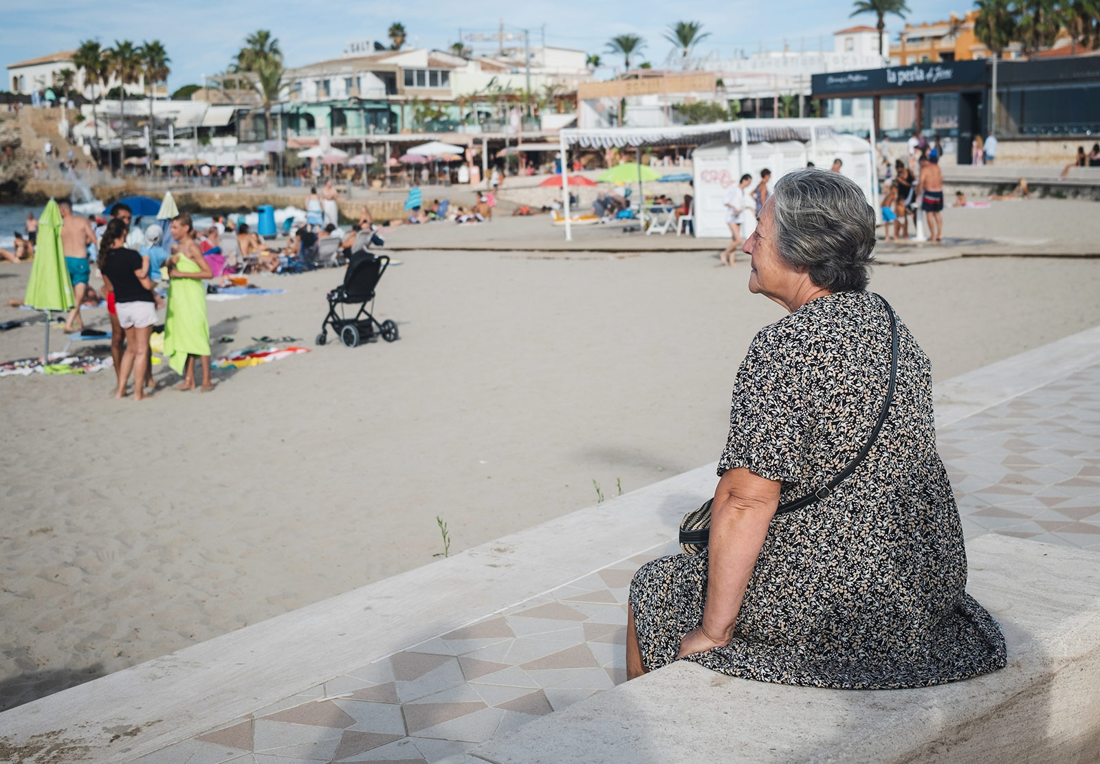 Woman sat looking out to sea