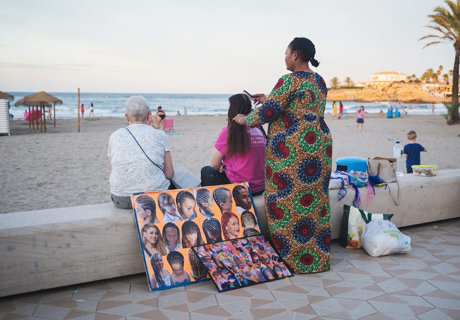 Woman braiding hair by the beach