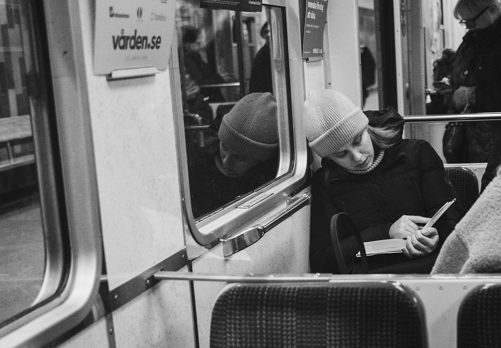 Woman reading book on train