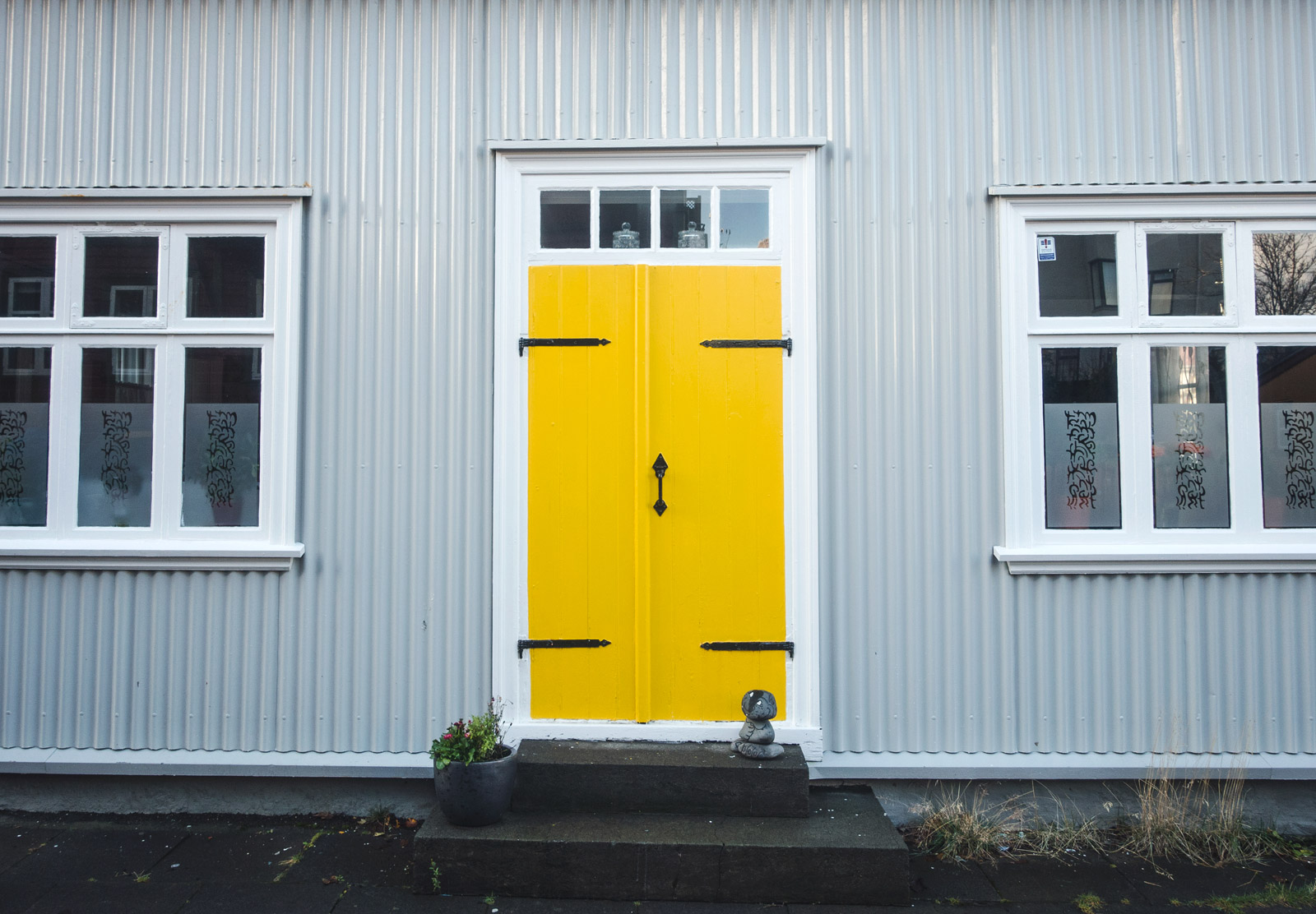 Grey building and yellow door