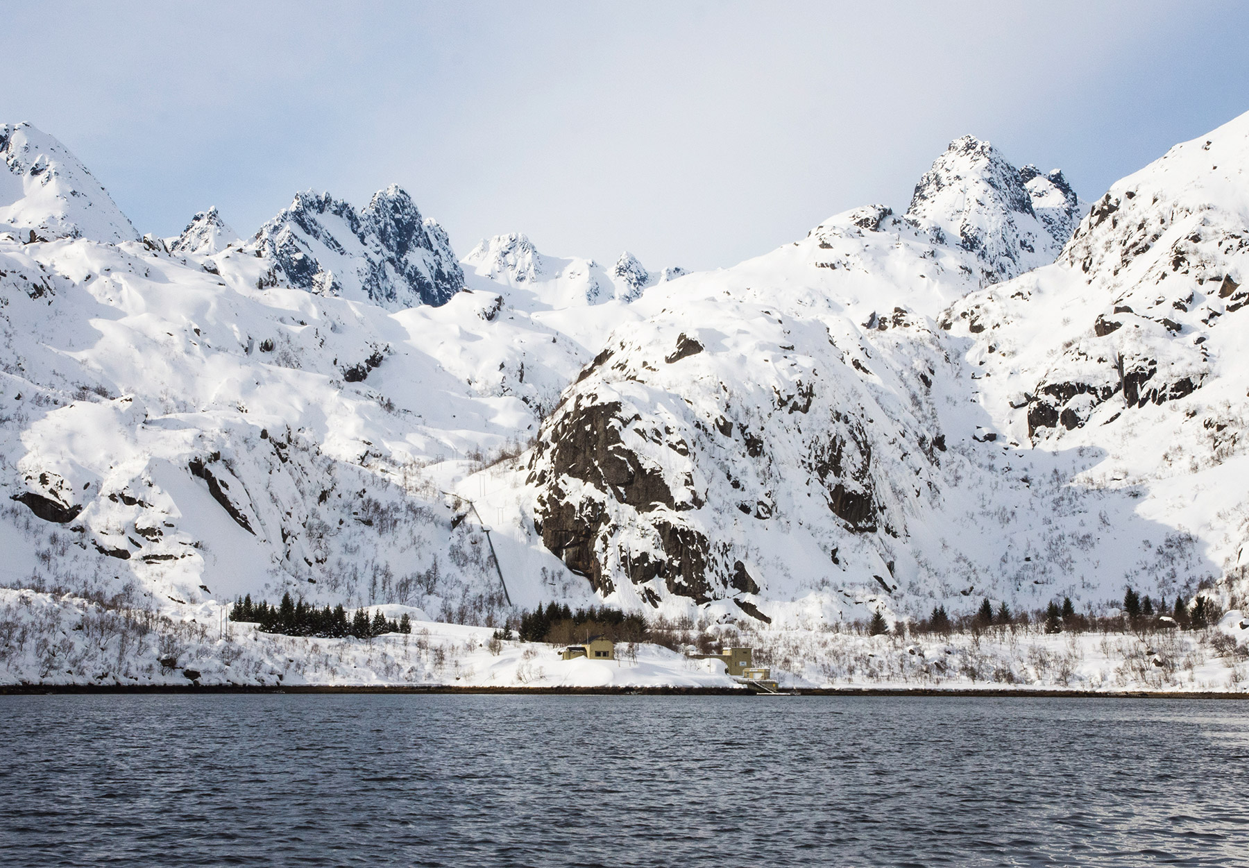 House at base of snowy mountain
