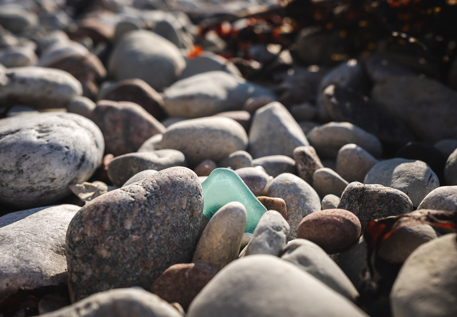 Turquoise glass on pebbles