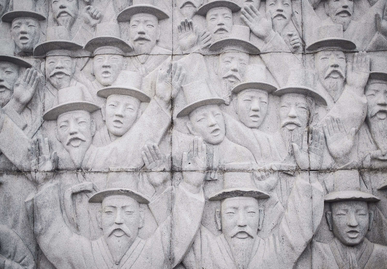 Faces carved into stone wall