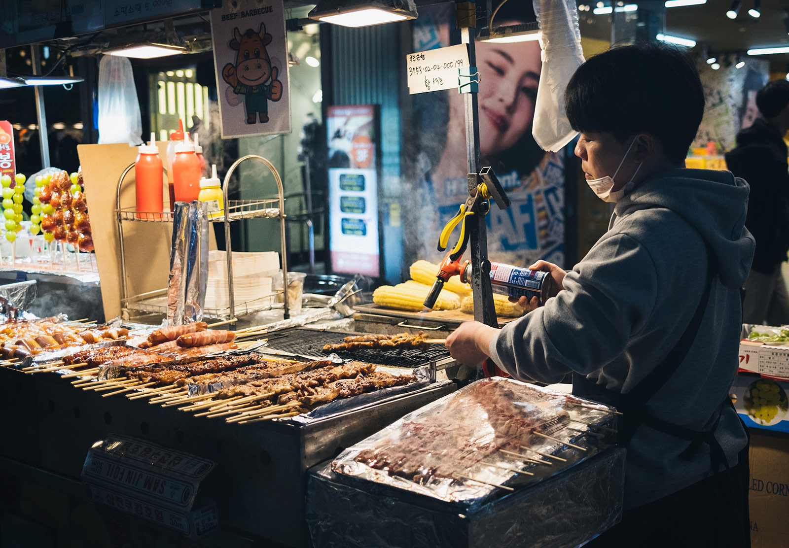 Man cooking meat at a market