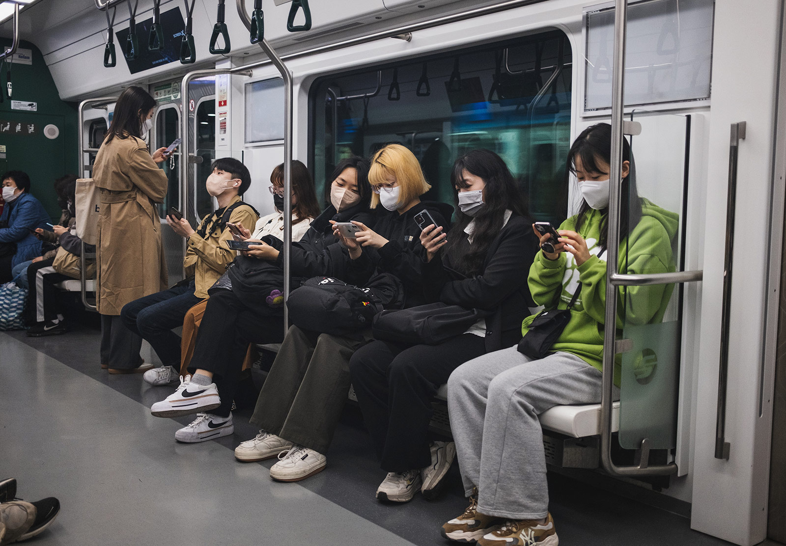 Subway passengers sitting in a line