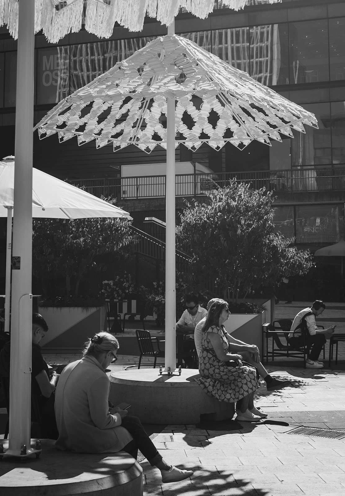 People sat under parasols in the city