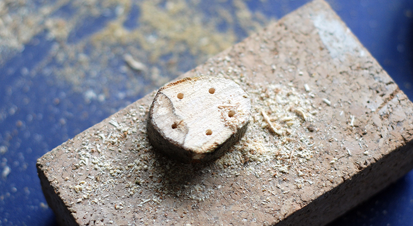 Wooden disc with 5 drilled holes