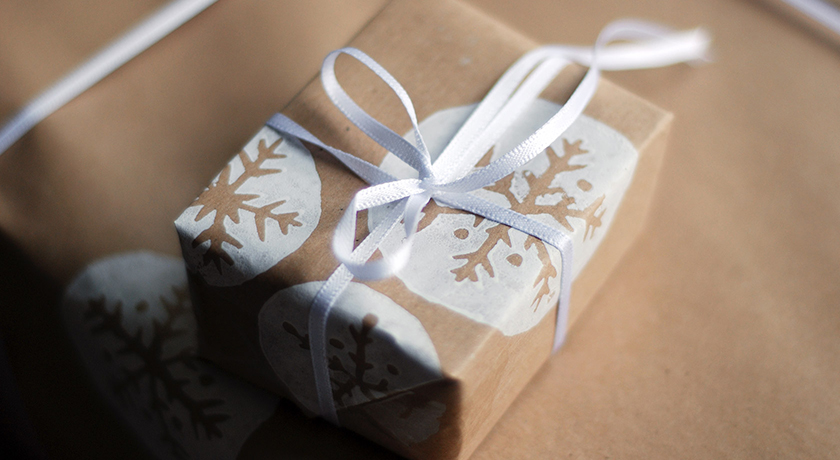Brown snowflake wrapping with white ribbon