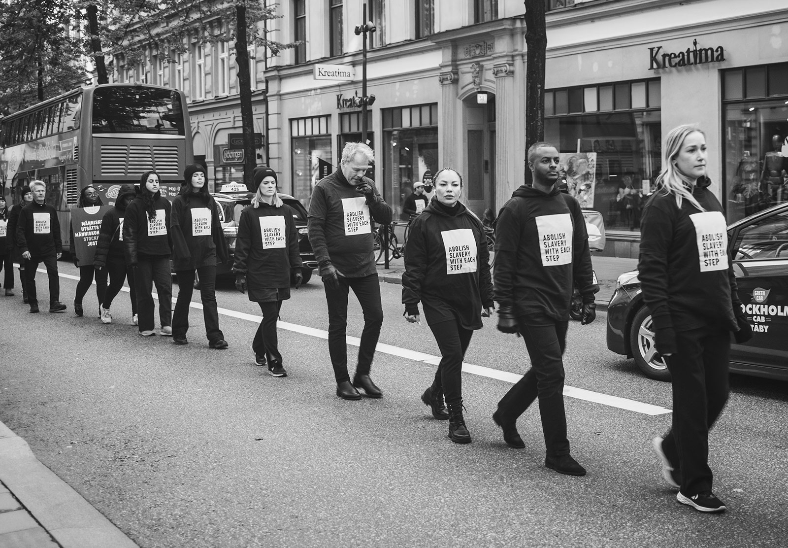Line of people wearing abolish slavery clothing