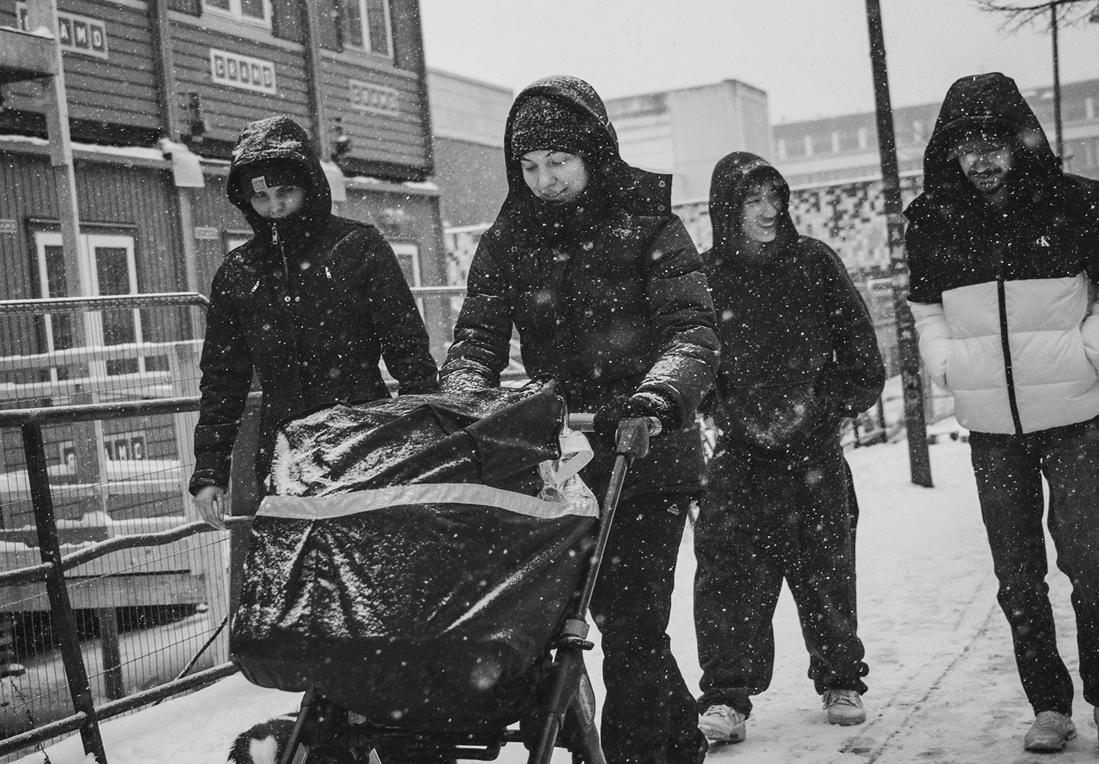 Woman pushing pram in the snow