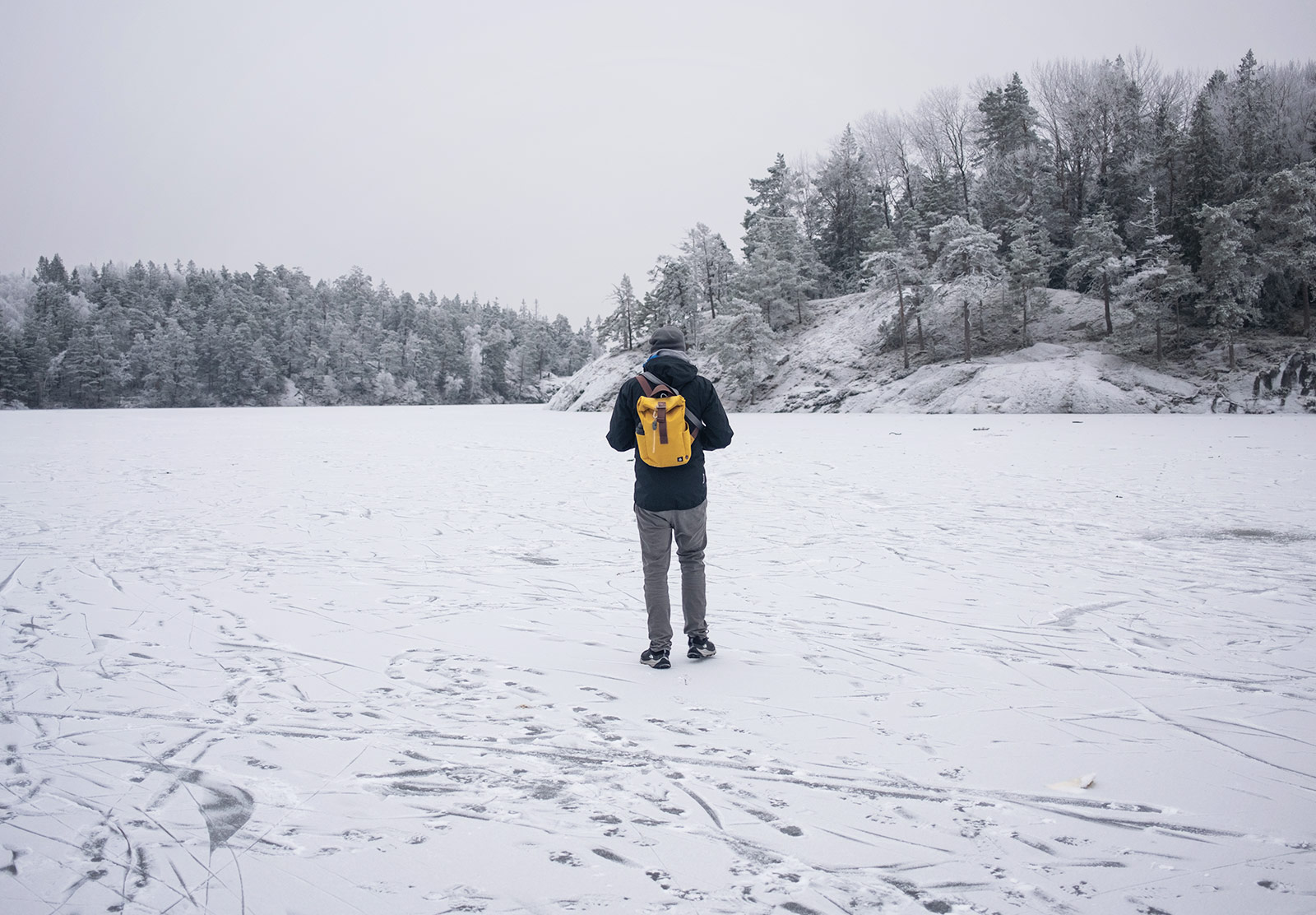 Man walking on frozen lake