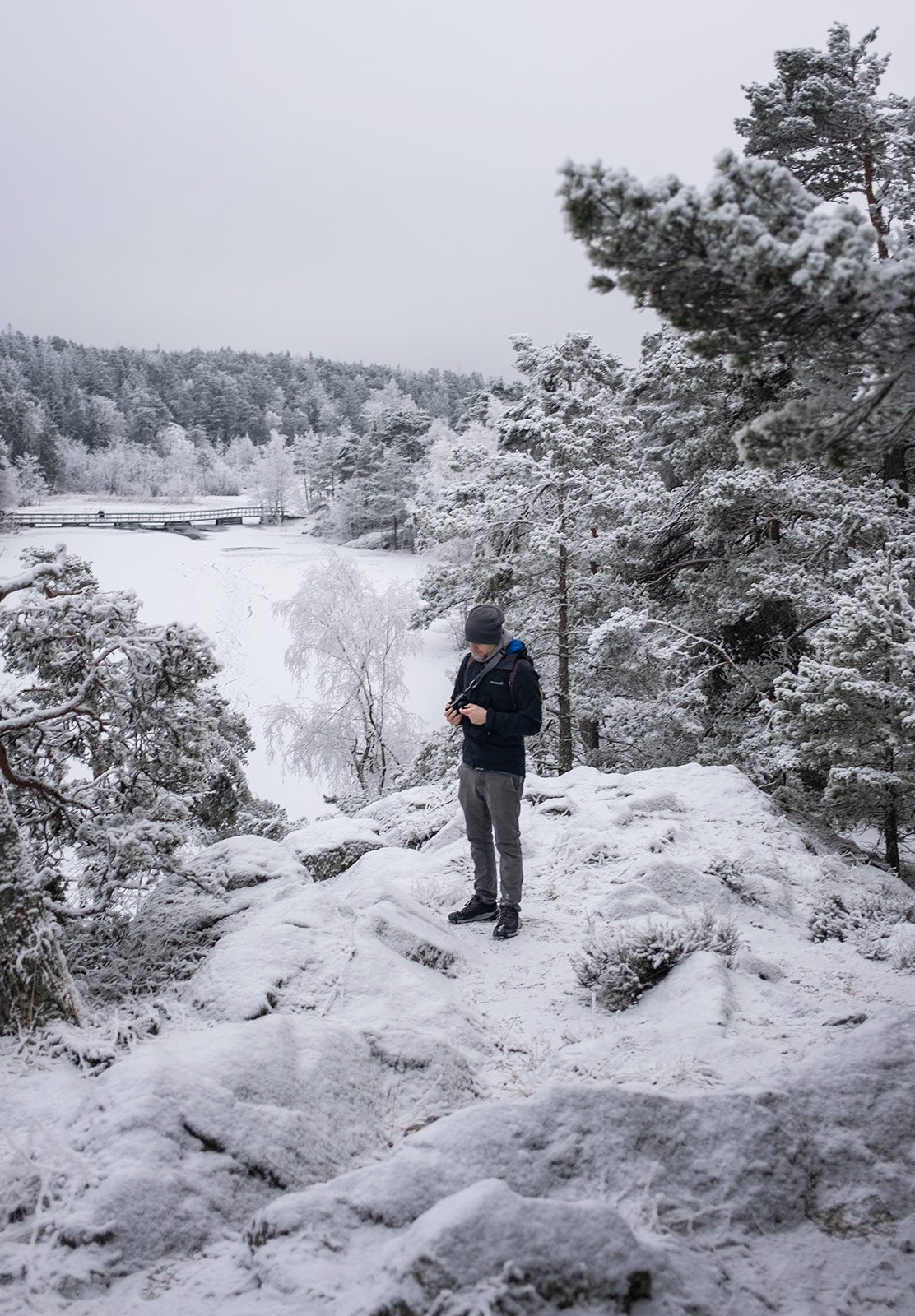 Man standing on snow covered rocks