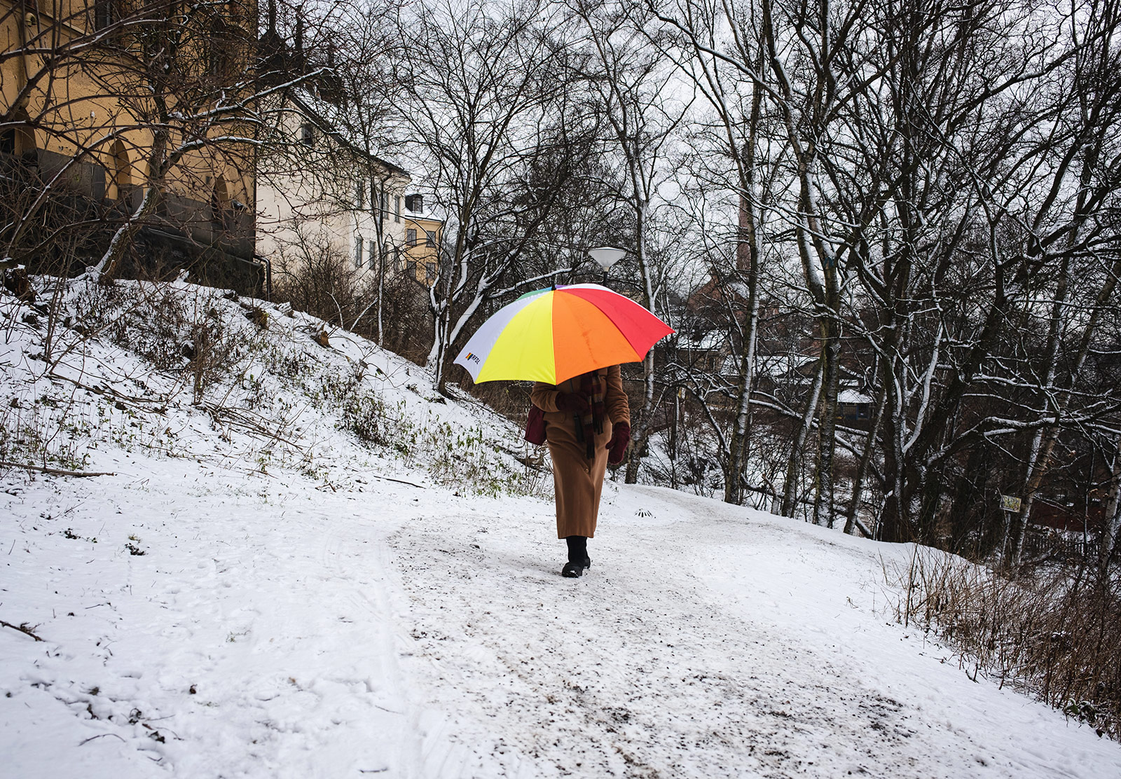 Woman carrying bright umbrella