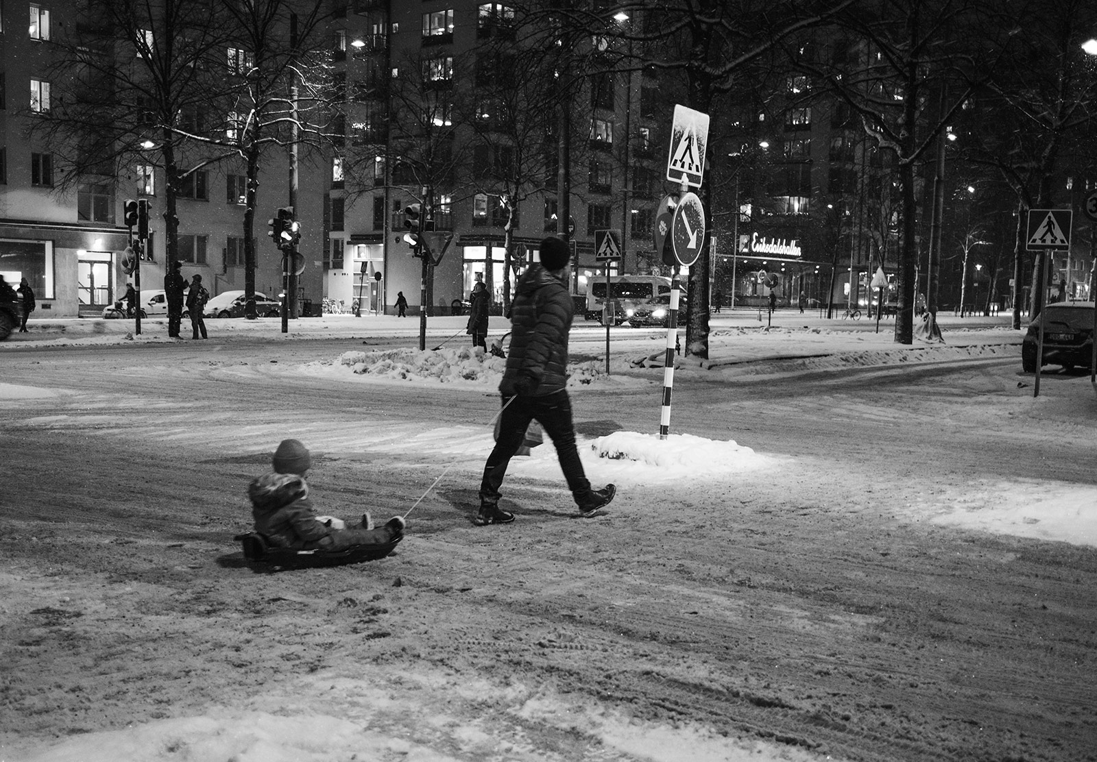 Man pulling child in sledge