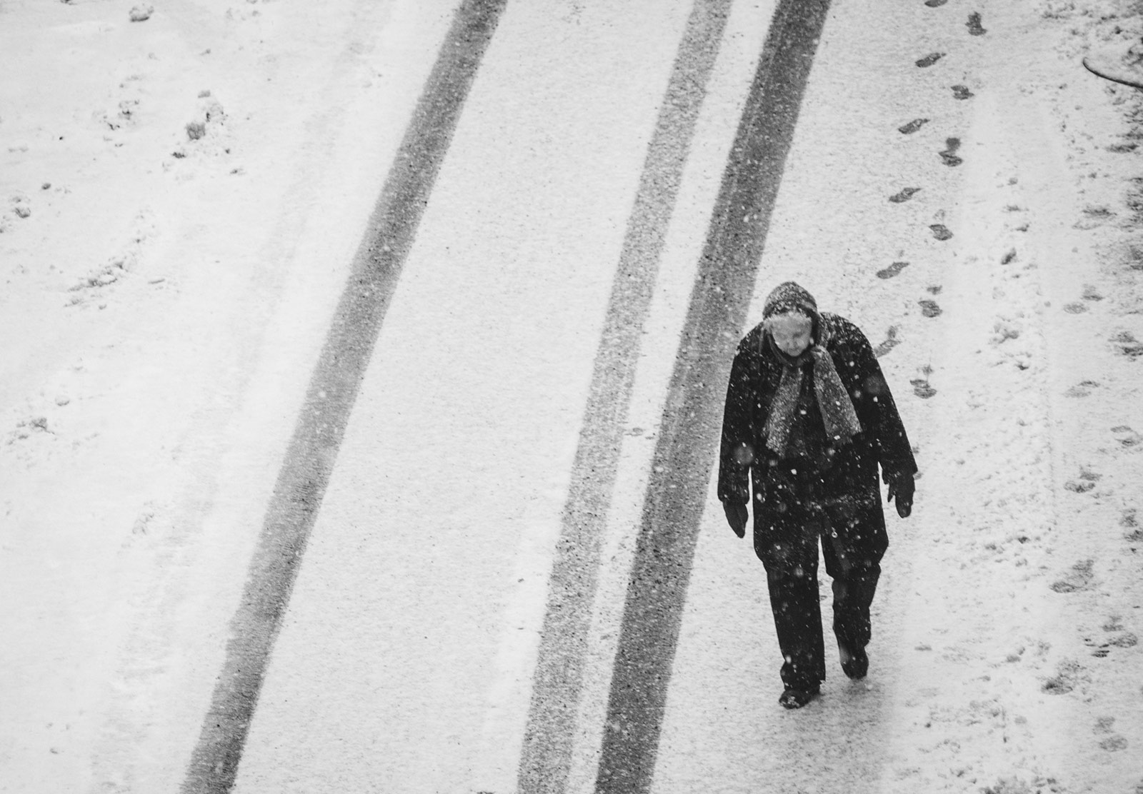 Elderly lady walking in snow