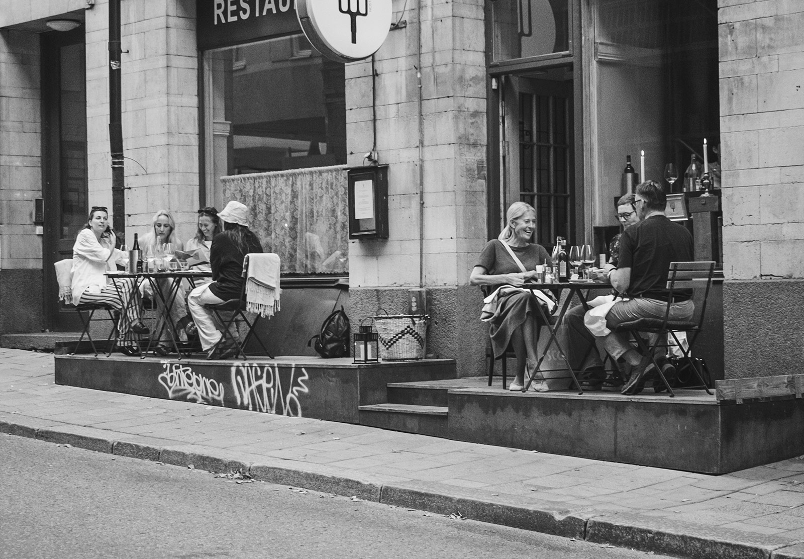 People drinking wine on outdoor tables