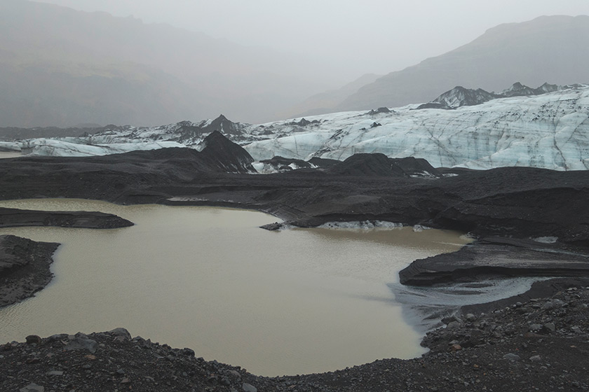 Blue glacier ice and black sand