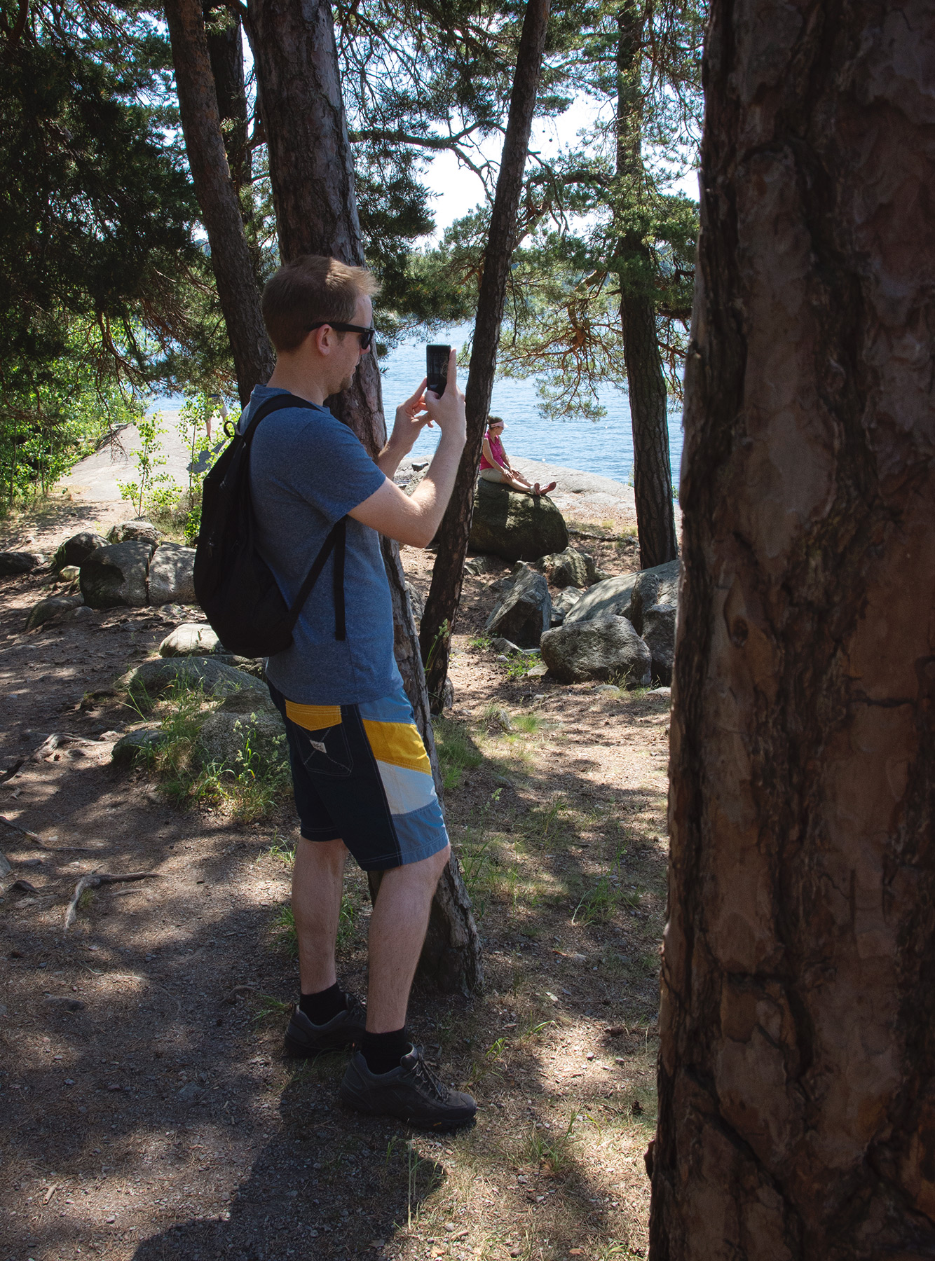 Man photographing through trees