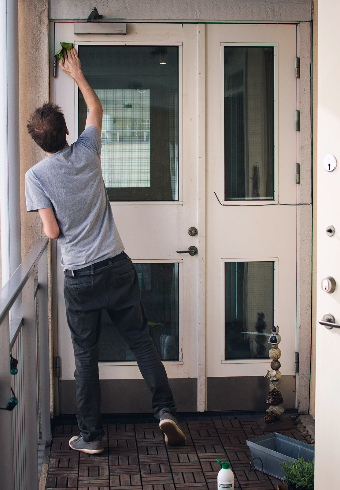 Man cleaning door