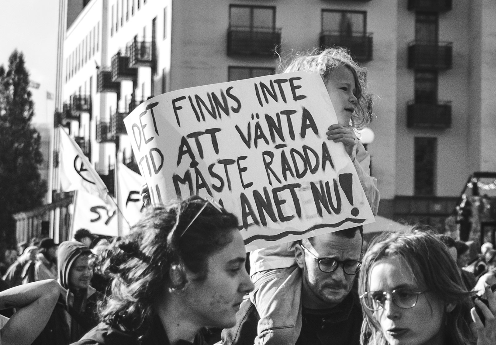 Child holding protest sign