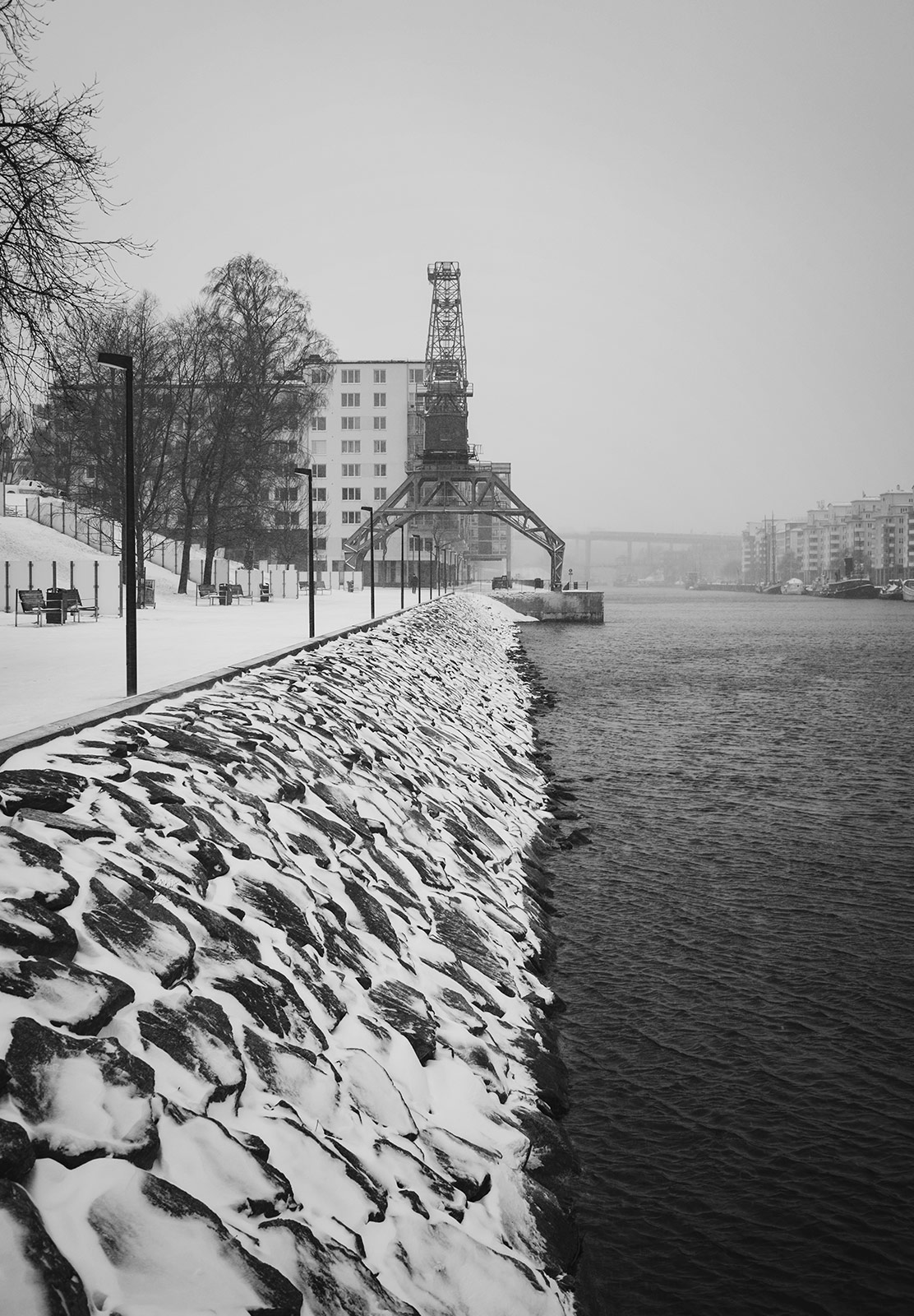 Snow on rocks by water