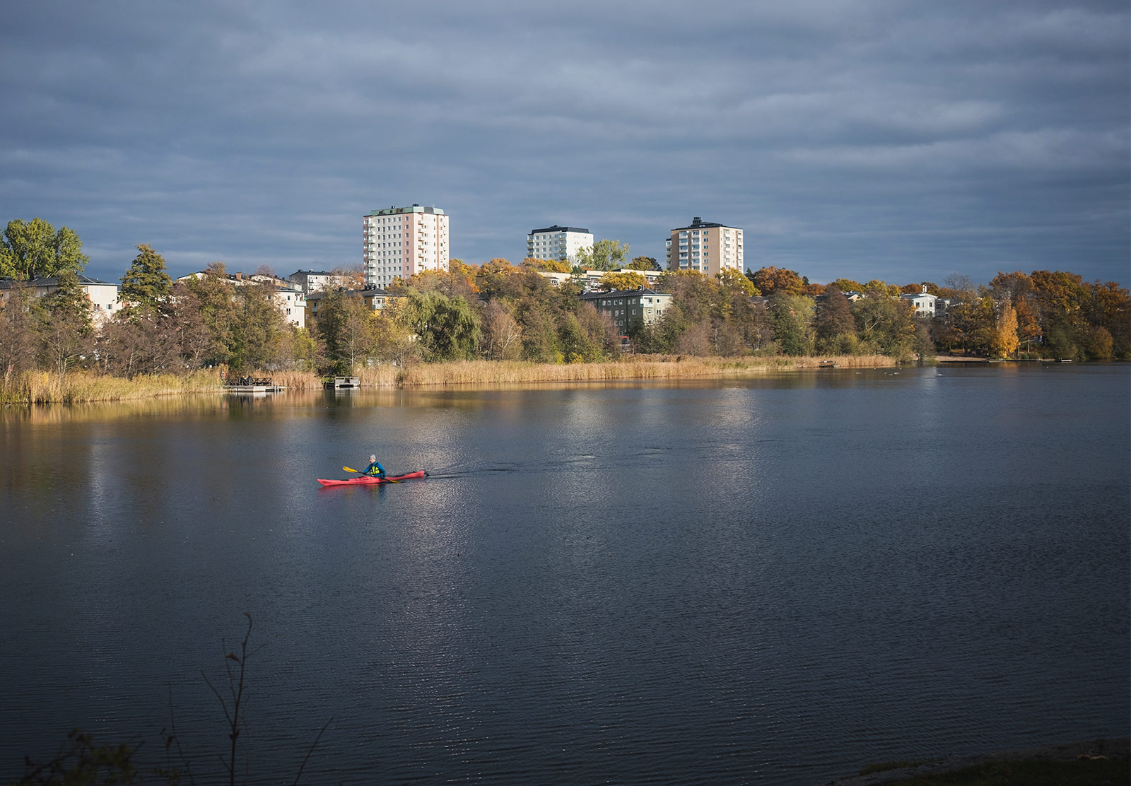 Person kayaking in city waterway