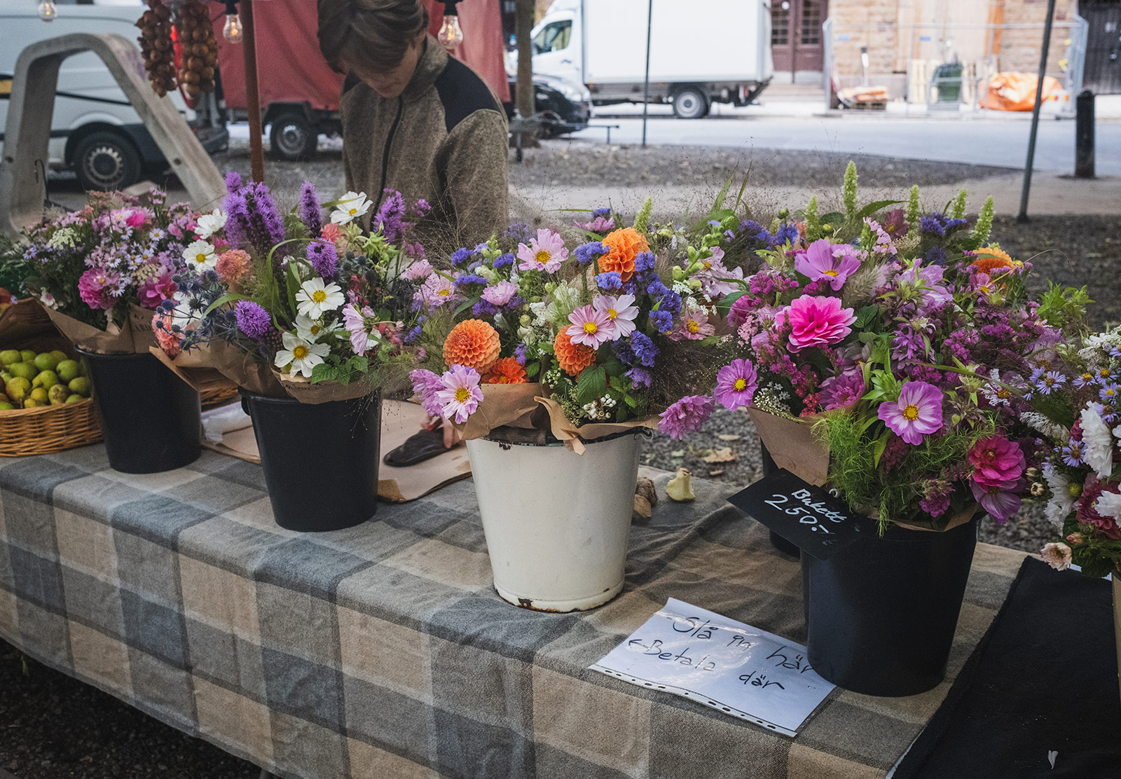 Buckets of flowers at a market