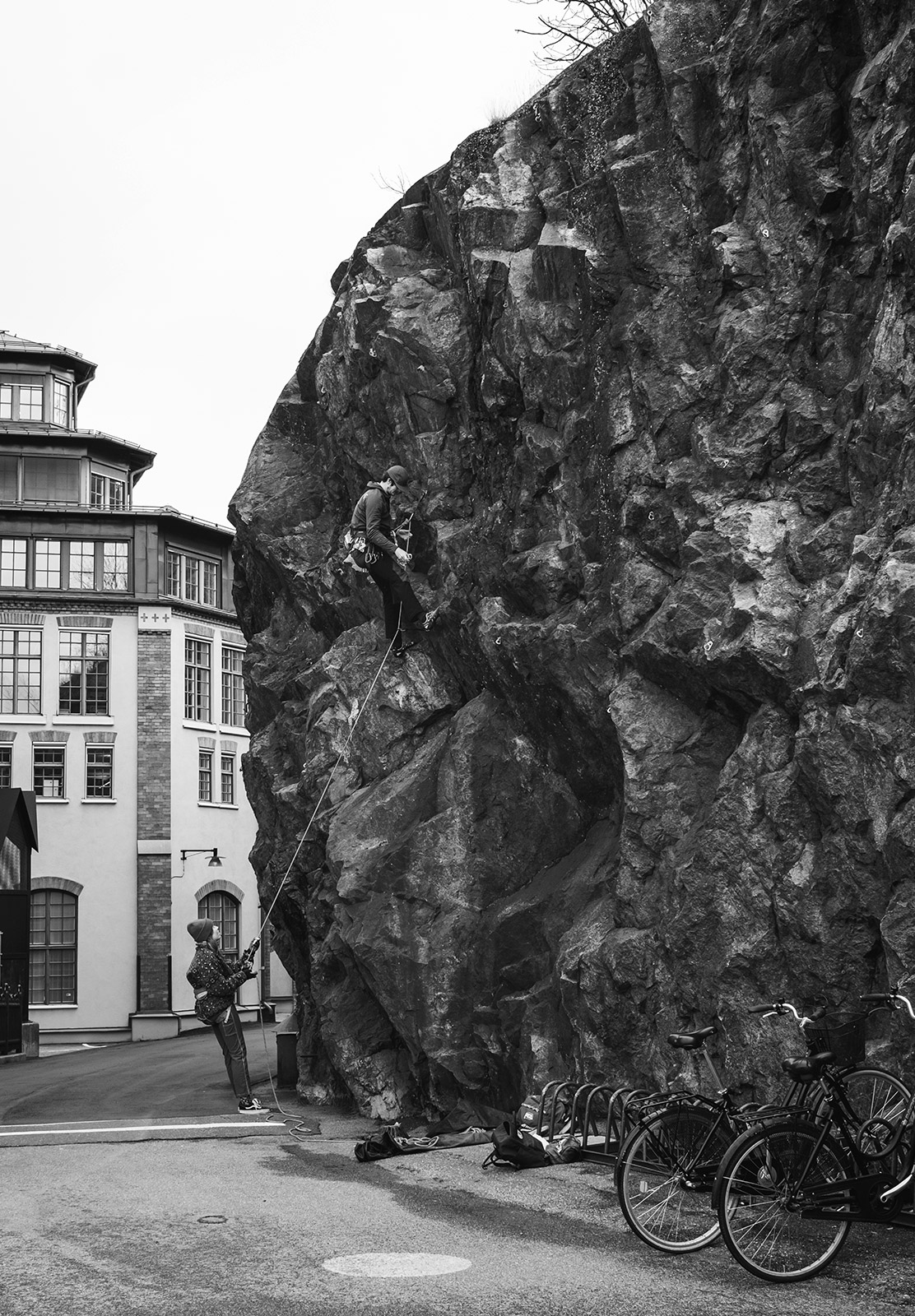 Man climbing rock in harness